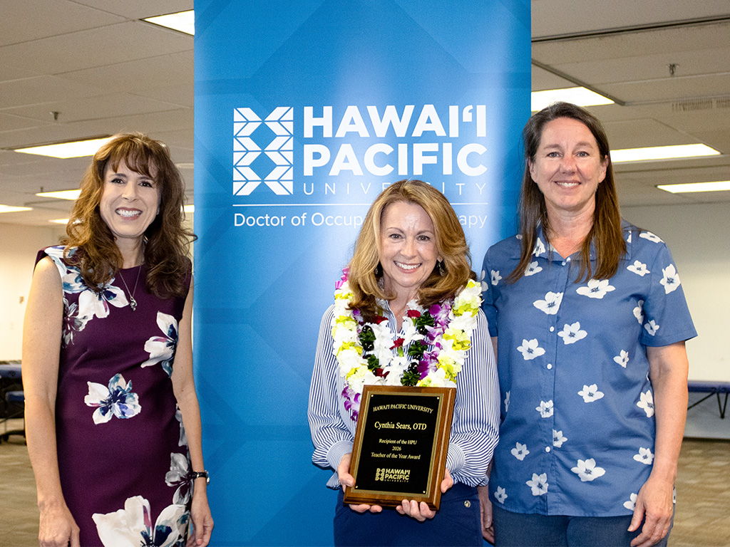 Jennifer Walsh (left), Cynthia Sears (center) and Brenda Jensen (right) celebrated on April 17 when the announcement was made to a classroom of cheering occupational therapy students