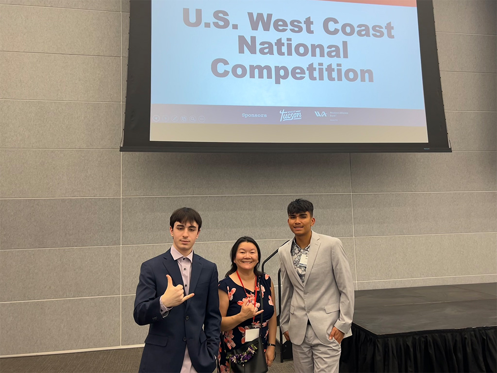 HPU students Michael Lozada-Longog (right) and Pierre Erard (left) with HPU College of Business Dean Amy Nyuyen-Chyung (center) at the Hult Prize Nationals West Competition in Tucson, Arizona 
