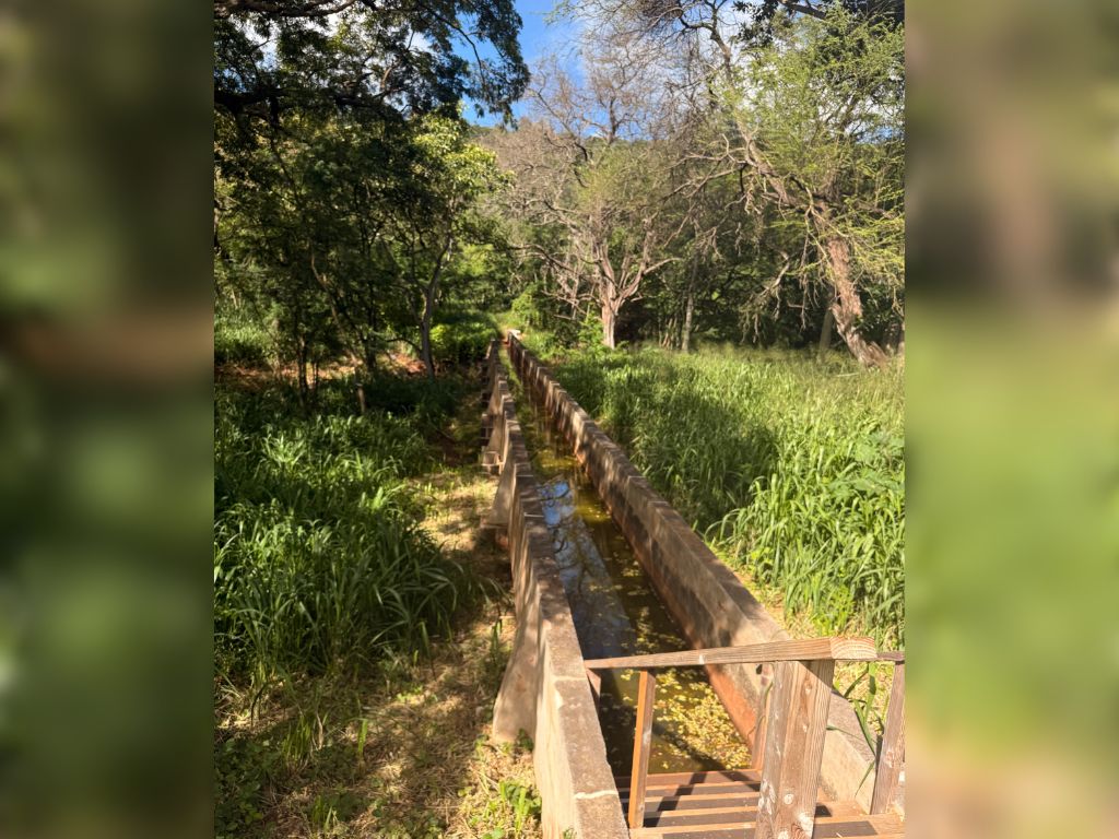 While no tents or buildings remain, features like water diversion exits help historians identify specific locations mentioned in photos and stories