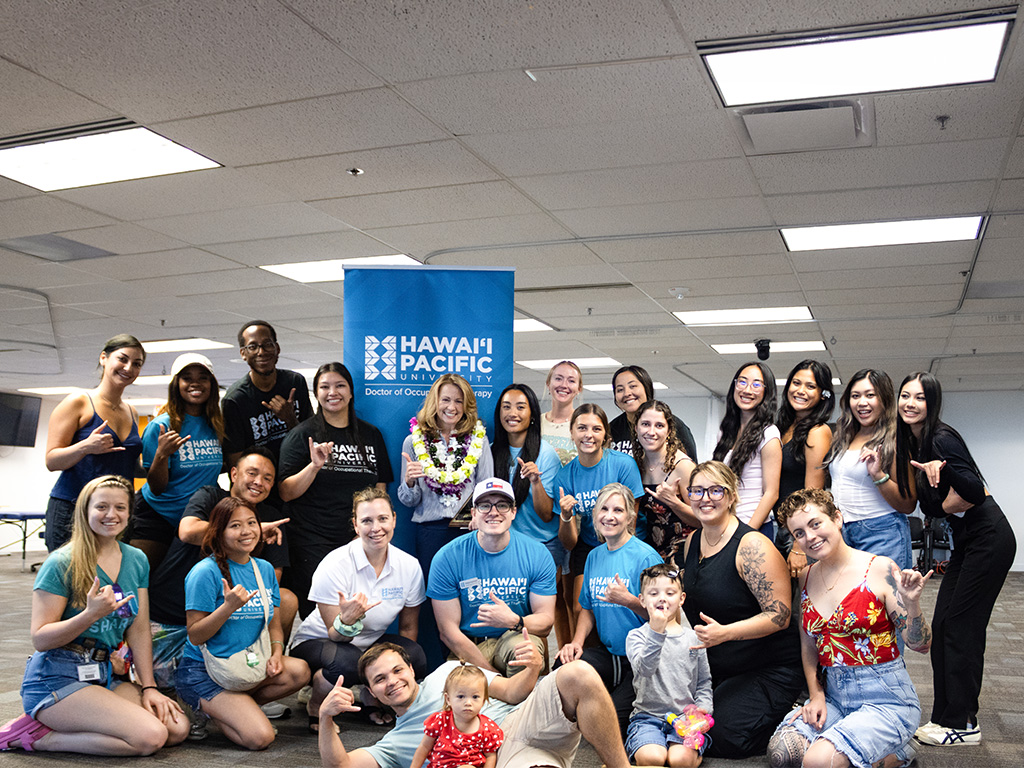 Cynthia Sears (seen with leis) won the 2026 HPU Teacher of the Year Award and celebrated with her occupational therapy students
