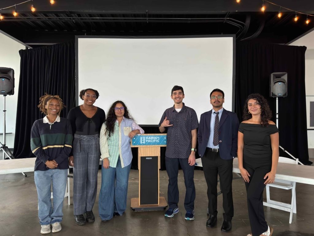 HPU Debate Society including its Coach Kaikane Glorioso, fourth from left, at the 2026 Pan Pacific Debate Championship hosted by HPU at Aloha Tower Marketplace 