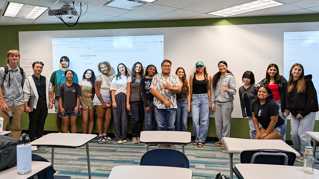 Ephraim Botulan '06 (center) with a class of HPU public health students in spring 2026