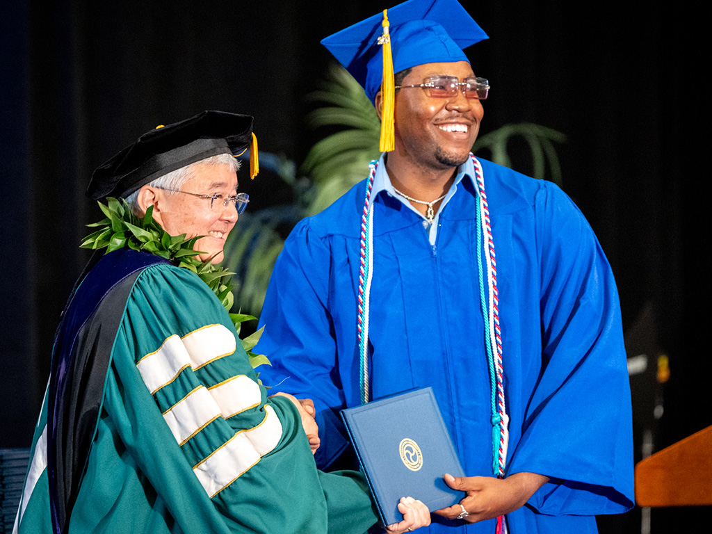 HPU President John Gotanda with an HPU graduate