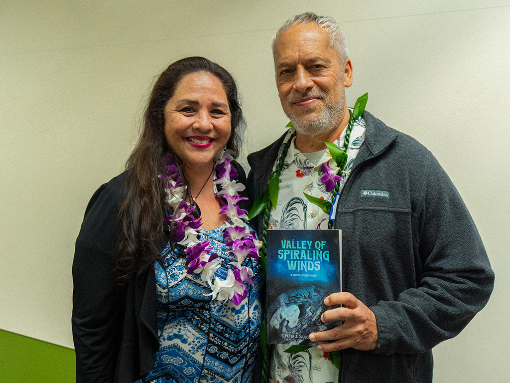 Pete Britos (right) with his book 'Valley of Spiraling Winds' at the Author Celebration event