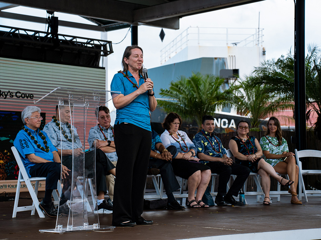 Dean Brenda Jensen (standing) and HPU academic deans spoke to new students and their families at Aloha Tower Marketplace