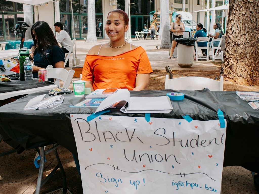  Vice President of Black Student Union, Maleyah Navarro, posed in front of her club's stand, eager to invite students to learn more about her club's upcoming events