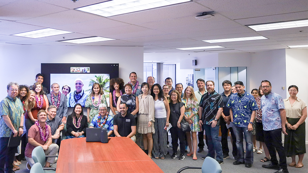 John F. Scarpa (seen on monitor) joined HPU President John Gotanda (seated, behind laptop) and members of the HPU 'ohana virtually for the plaque ceremony