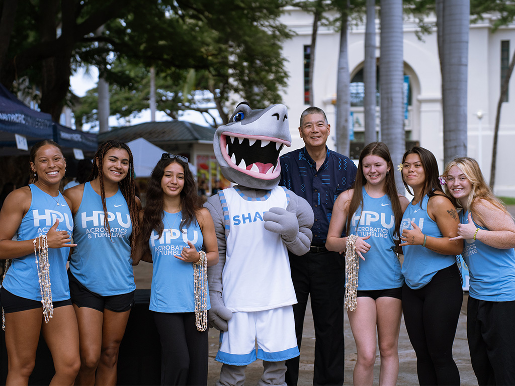 HPU Provost and Senior Vice President Alan Shoho (fourth from right), Sharky, and HPU student athletes welcomed new students to campus
