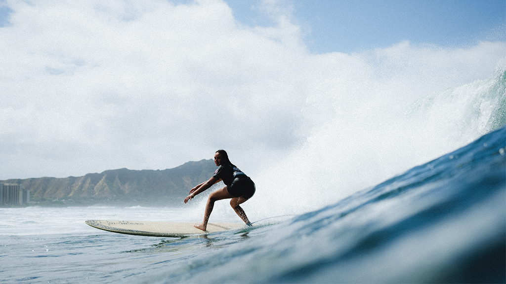 A Hawai'i high school student-athlete surfs in Waikiki. HPU's new Surf Team will give Hawai'i high school students the opportunity to compete at the collegiate level without leaving home. Photo by Ricky-Thomas Serikawa