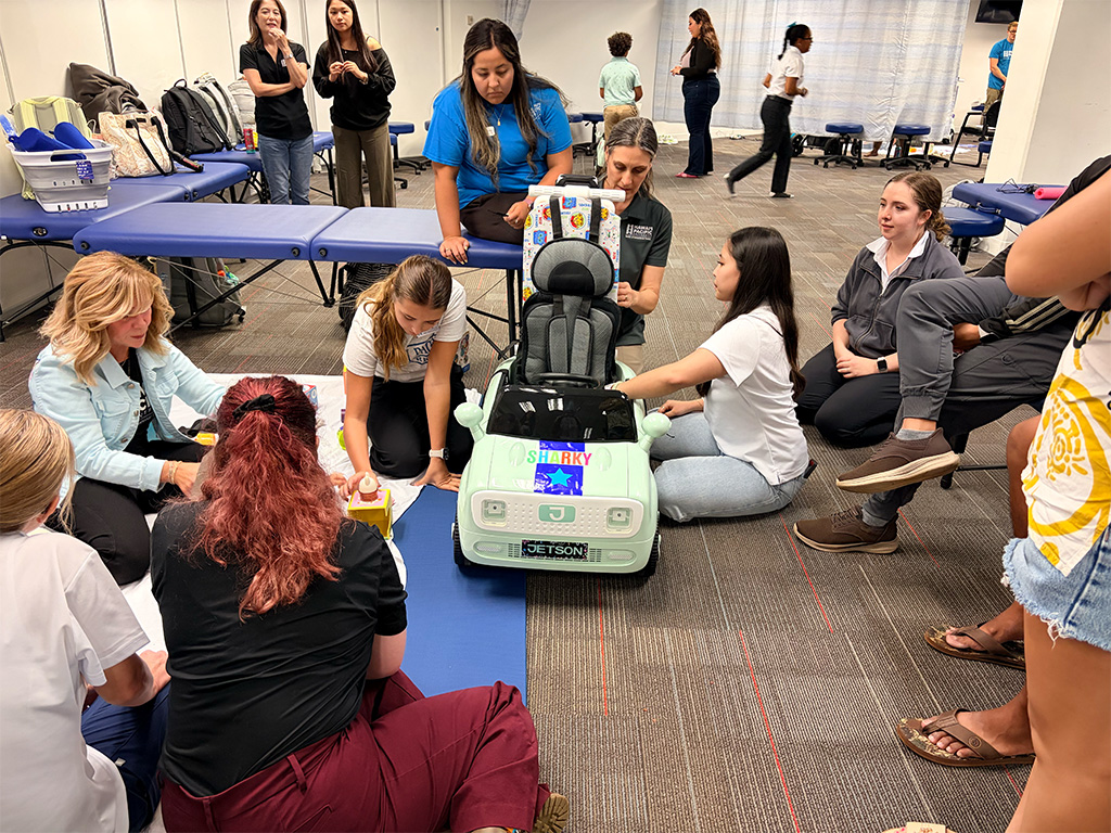 Doctor of Occupational Therapy students and faculty work to customize the ride-on cars