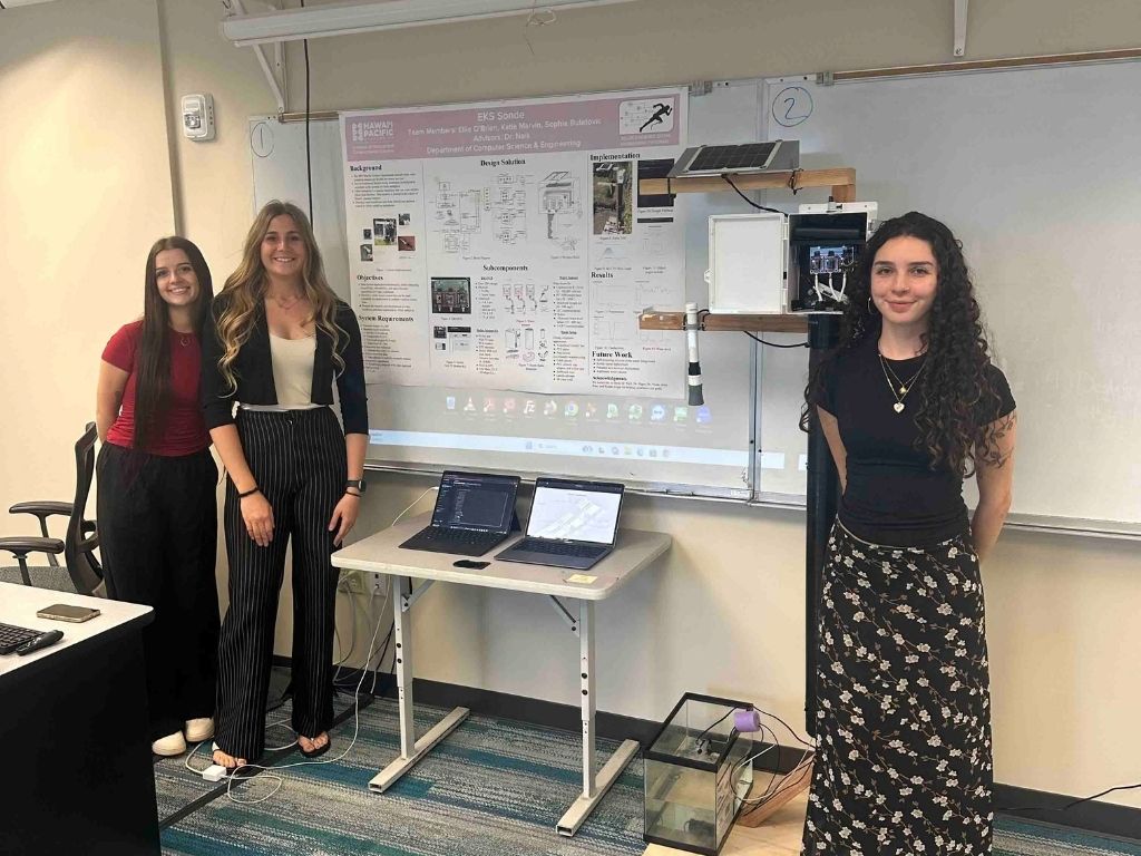 From left to right, electrical engineering alums Katie Marvin, Ellie O'Brien, and Sophie Bulatovic at the Engineering Poster Session, presenting the sonde they developed 