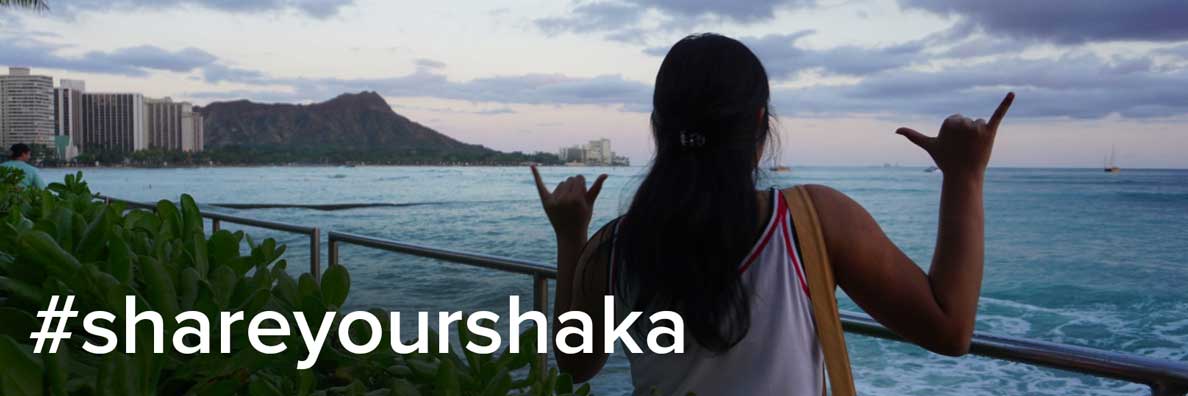 girl making shaka hand gesture