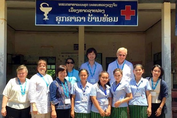 Dr. Christian Gloria stands with nurses and medical staff at a hospital in a semi-remote village in Laos